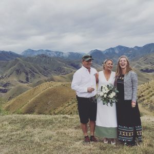Wanaka Marriage Celeebrant laughing with couple in Mountains at Tarras Otago