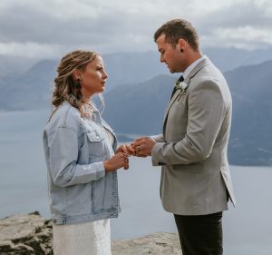 Couple exchanging rings during Queenstown Mountain Top elopement with Siobháin the Celebrant