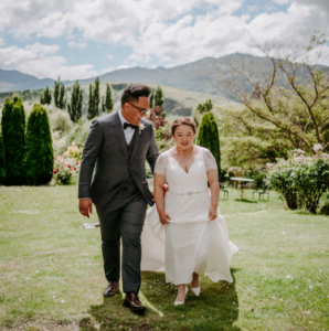 Groom & Bride walking and laughing in garden